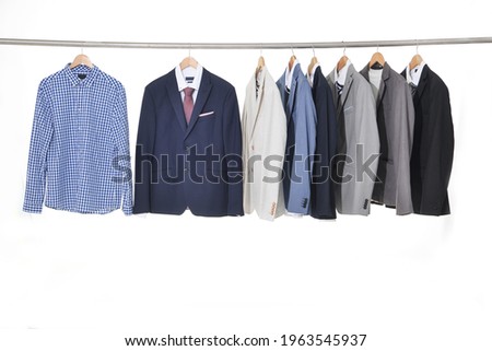 Row of man suit ,striped Shirts with ties on hangers


