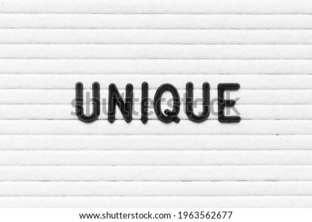 Black color letter in word unique on white felt board background
