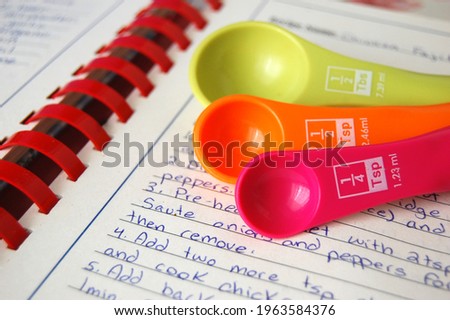 Colorful measuring spoons with spices and herbs Royalty-Free Stock Photo #1963584376