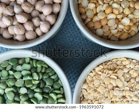 Round bowls with legumes, peas, chickpeas and lentils on a wicker grey background. High quality photo