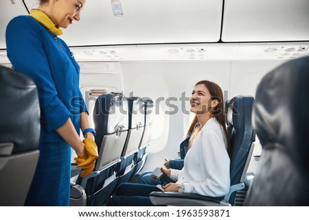 Young female passenger looking excited before the flight Royalty-Free Stock Photo #1963593871