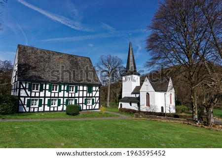The listed Protestant Kreuzkirche in Bergneustadt-Wiedenest is one of the colourful churches in the Oberberg region. Many murals can be seen inside these small fortified churches. Royalty-Free Stock Photo #1963595452