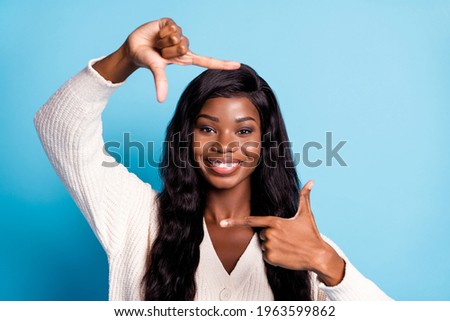 Photo portrait black skinned girl showing cadre with fingers smiling taking photo isolated bright blue color background