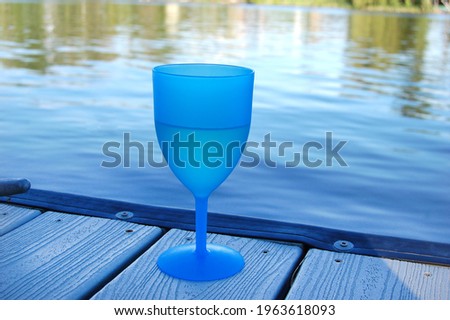 Wine Glass on a Dock by Water
