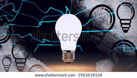 Composition of lit light bulb over light bulb icons on black background. lightbulb moment, electricity, inventions and technology concept digitally generated image.