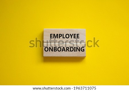 Employee onboarding success symbol. Wooden blocks with words 'Employee onboarding' on beautiful yellow background. Business and employee onboarding success concept. Copy space.