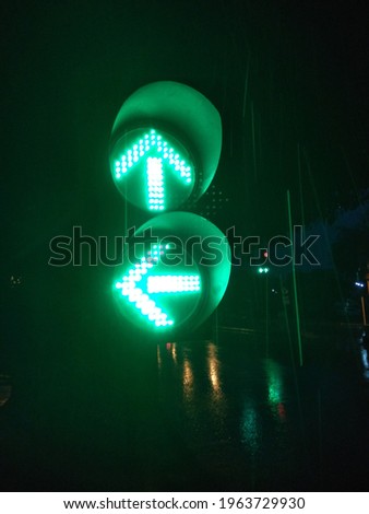 traffic signal light at dark rainy night 