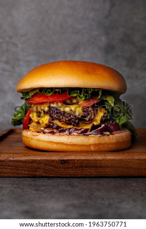 Burger with two beef patties, herbs, pomegranate and cheese