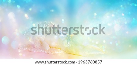 Relaxing iridescent angel in a glowing field of abundant colored light as a symbol of hope that all is well  Royalty-Free Stock Photo #1963760857