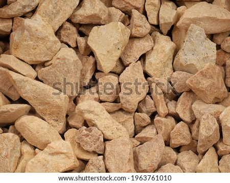 terracotta chipping stones, orange stone texture as background.