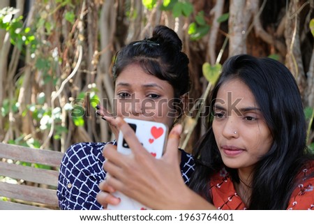 A closeup shot of two South Asian female friends taking a selfie