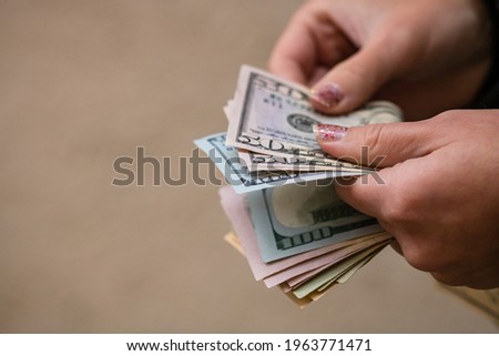Selective focus on detail of USD banknotes. Counting or giving United States Dollars banknotes. World money concept, inflation and economy concept