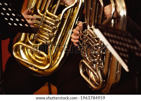 Close up of a musician playing tuba at a brass concert