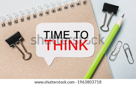 Text TIME TO THINK on a white sticker with office stationery background. Flat lay on business, finance and development concept