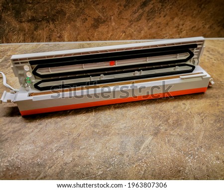Photo of a vacuum packaging sealer on a table in the kitchen
