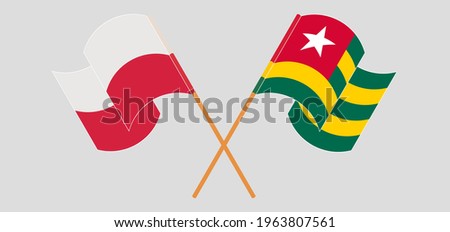 Crossed and waving flags of Poland and Togo