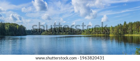 Beautiful forest lake in Russia. Panoramic view of beautiful lake landscape in Pskov region, Russia. Royalty-Free Stock Photo #1963820431