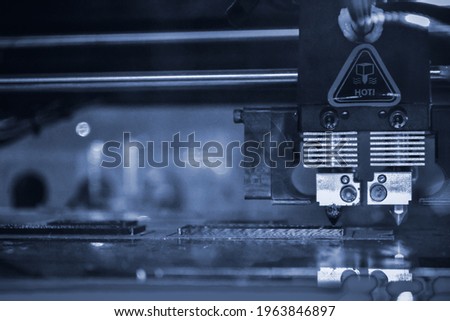 3D printer printing black shapes close-up Automatic three dimensional 3d printer Royalty-Free Stock Photo #1963846897