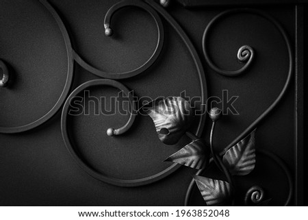Decorative elements of the gate, forged products in the form of plants on the metal gate Royalty-Free Stock Photo #1963852048