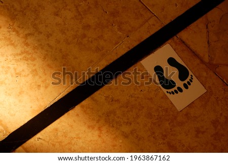 Footprint sticker as a marker to keep your distance in public areas.