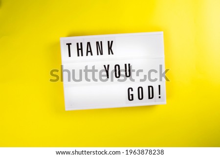 Lightbox with text message THANK YOU GOD isolated on yellow background. Concept of happiness, prayer, faith, hope, gratitude, gratefulness, survive, luck, chance, godsend, pleased, Thanksgiving Day