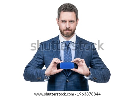 confident businessman man in suit and safety helmet demonstrate device isolated on white, gadget.