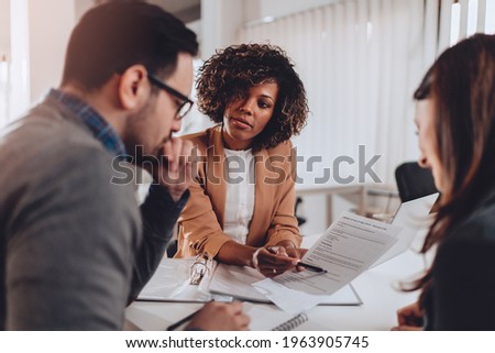 Couple preparing to sign a contract of sale Royalty-Free Stock Photo #1963905745