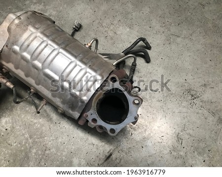 diesel particulate filter or DPF at car repair station. Royalty-Free Stock Photo #1963916779