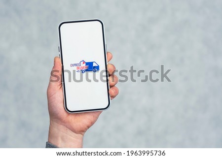 Express delivery in your phone. A man holds a smartphone with an icon on a white screen in his hands