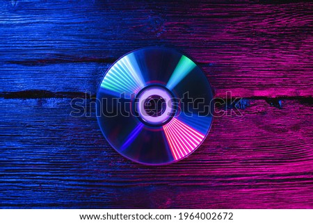 Compact disc on the table in the neon lights.