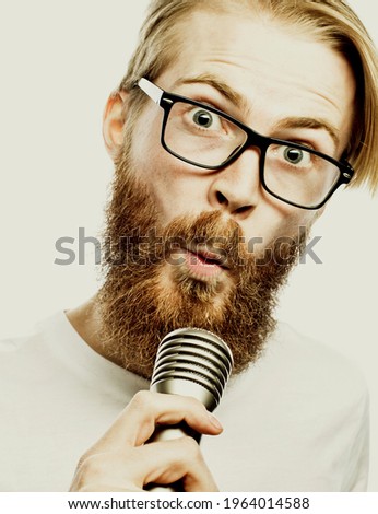 lifestyle and people concept: young man singing with microphone