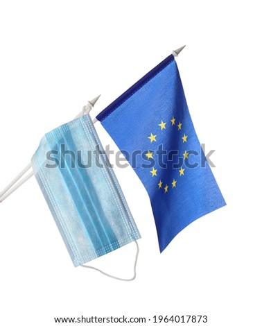 Medical mask on the background of the flag of the European Union, isolated, concept of coronavirus (COVID-19), closeup.