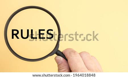 Magnifying glass word rules background.
Concepts of rules.
top view.