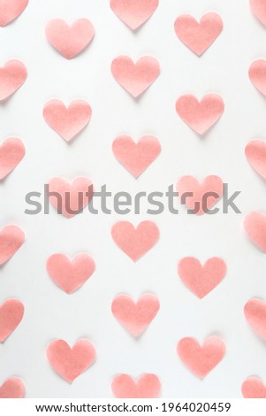 Vertical background of evenly arranged pale pink hearts.
