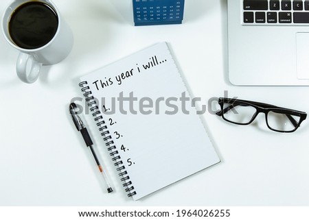 New Year's Resolutions Concept - Laptop, a cup of coffee and eyeglass background.