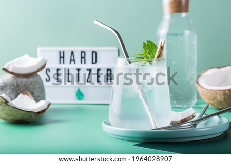 Tropical hard seltzer cocktail with coconut water and ice