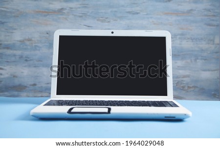 White laptop on the blue business desk.
