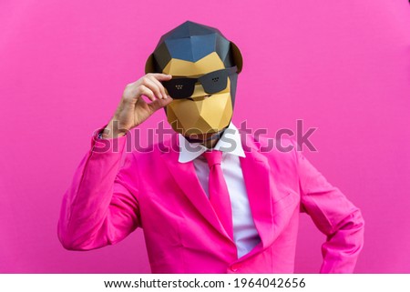 Happy man with funny low poly mask on colored background - Creative conceptual idea for advertising,adult with low-poly origami paper mask doing funny poses Royalty-Free Stock Photo #1964042656