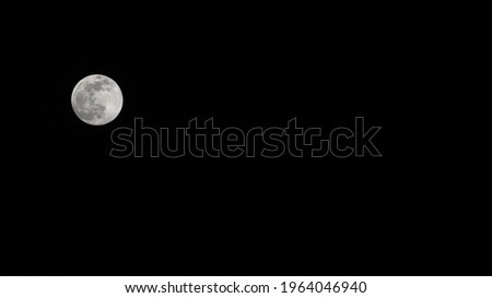 Full moon in dark sky.