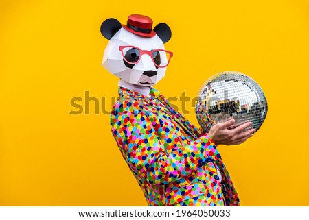 Happy man with funny low poly mask on colored background - Creative conceptual idea for advertising,adult with low-poly origami paper mask doing funny poses Royalty-Free Stock Photo #1964050033
