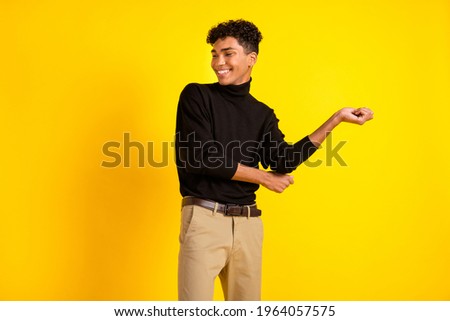 Photo of funny cute dark skin guy dressed black turtleneck dancing isolated yellow color background