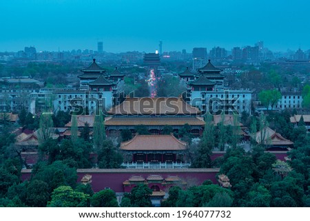 Overlooking the Red watchtower and skyline in Beijing from Jingshan Park at night. Chinese characters mean "Jingshan Park".