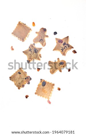 Cookies in different shapes, gluten-free, lactose-free, healthy dessert with dark chocolate and raisins on an isolated white background, levitation