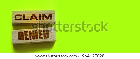 Wooden Blocks with the text: Claim Denied. Insurance Business concept.