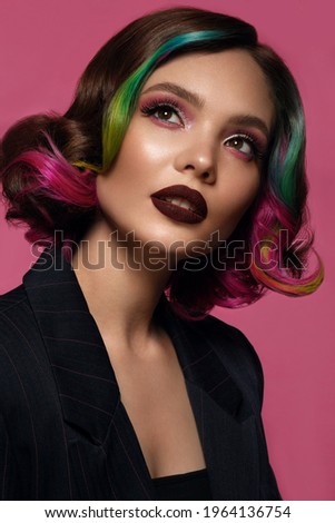 Beautiful woman with multi-colored hair and bright make up and hairstyle.