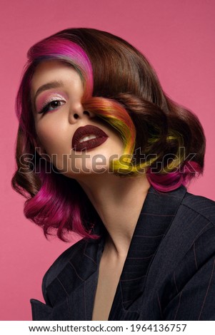 Beautiful woman with multi-colored hair and bright make up and hairstyle. Royalty-Free Stock Photo #1964136757
