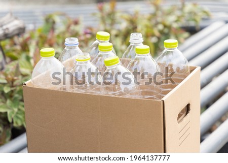 Plastic drinking bottles are separated in paper boxes. For easy disposal of the right type of waste For good environment