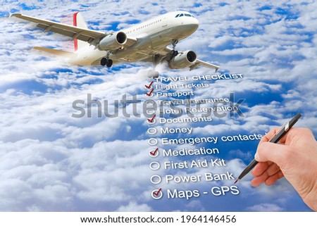 Hand write a Travel Checklist over a cloudy sky and airplane - concept image