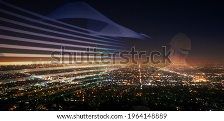 Male engineer on night light city background, power energy and sustainable resource environment technology