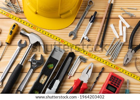 All tools supplies home construction on the wooden table background. Building tool repair equipments. Royalty-Free Stock Photo #1964203402